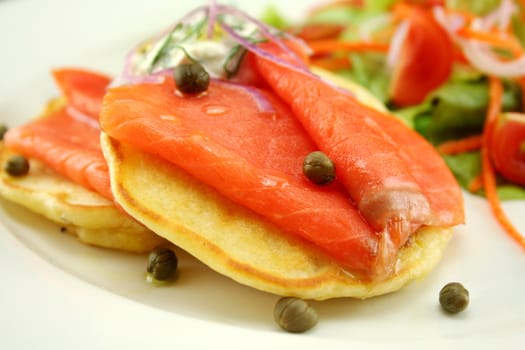 Corn fritters topped with smoked trout with dill, capers and cottage cheese.