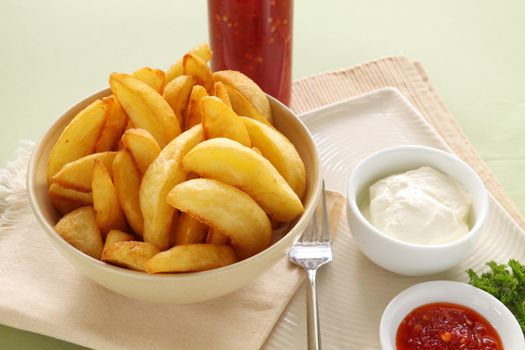 Potato wedges with sour cream and sweet chilli sauce.