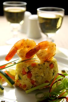 Delicious grilled shrimps on a risotto stack with side salad.