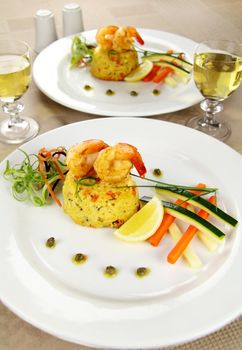 Delicious grilled shrimps on a risotto stack with side salad.