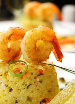 Delicious grilled shrimps on a risotto stack with side salad.