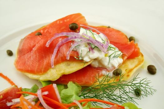 Corn fritters topped with smoked trout with dill, capers and cottage cheese.