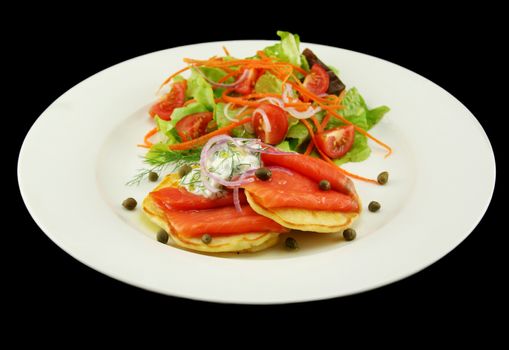 Corn fritters topped with smoked trout with dill, capers and cottage cheese.