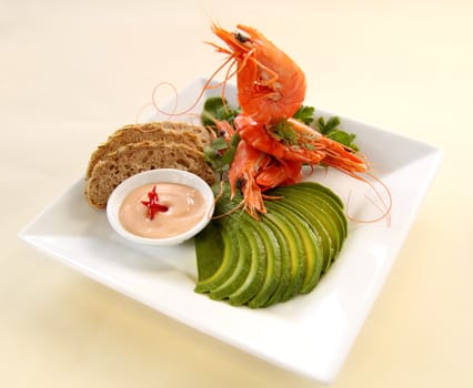 Shrimp stack with avocado, bread and dip.