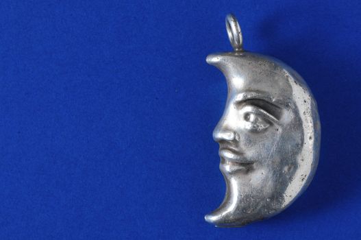 Half Moon Silver Jewel over a Colored Background