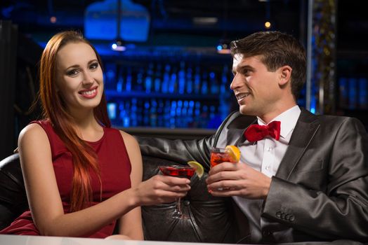 Young couple talking in a nightclub, have fun