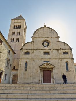 woman in front of church of St. Mary, Zadar, Croatia       