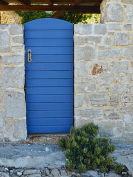 Blue door from garden on island of Prvic, croatia        