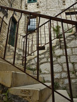 Stairs with metal brackets in old town Shibenik