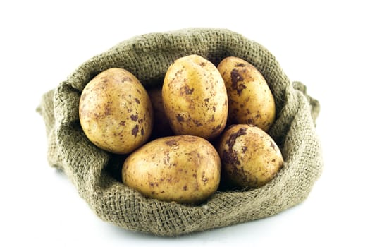 potatoes in burlap sack isolated on white background