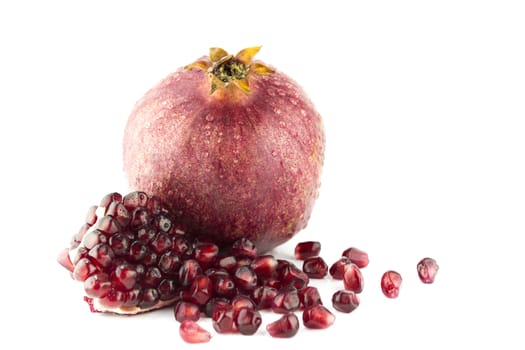 Ripe pomegranate fruit and part isolated on white background .