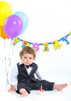 Babies' first birthday one year old with colorful balloons. Isolated over white.