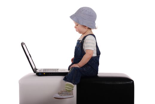 Little boy sitting with a laptop isolated on the white