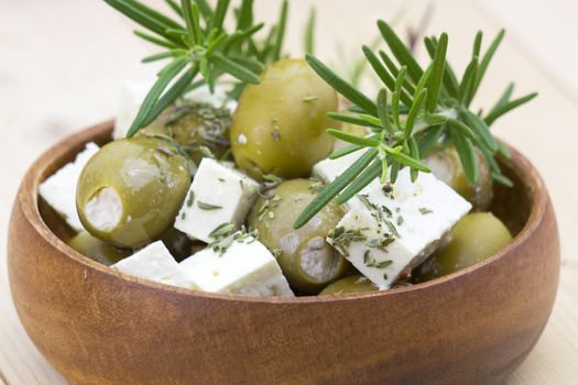 feta cheese and olives with herbs in olive oil