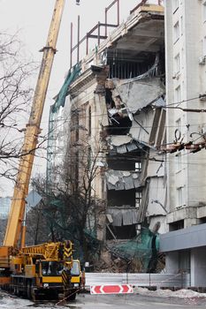 Big ruined office building and big crane near it