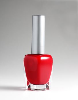 Red nail varnish at light background