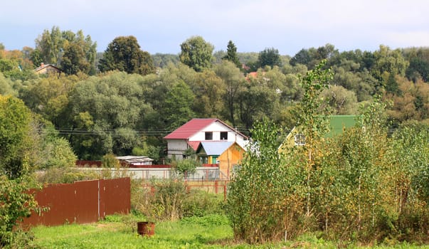 The house in the village in the trees