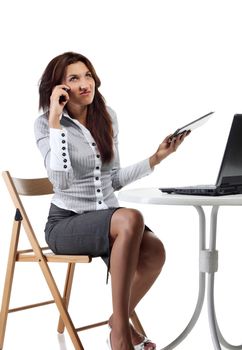 Young women with computer talking by phone