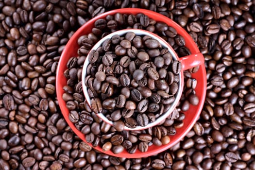 Cup on the saucer full of coffee beans