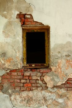 Broken window at old wall