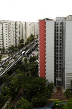 Vertical shot of a sky train and track system in a modern neighborhood. 