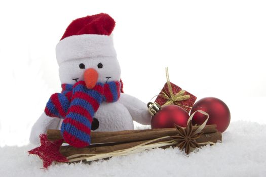 snow man (toy) with christmas decoration and artificial snow 