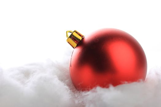 red christmas balls on snow with white background 