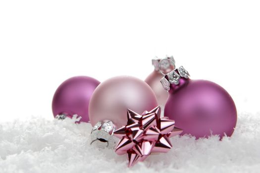 pink christmas balls with loop on artificial snow 