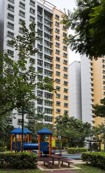 A vertical shot of a residential estate with playrground on the foreground. 