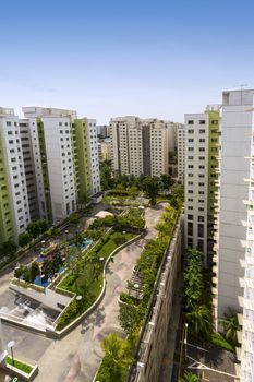 Vertical high angle shot of a residential estate with roof facilities of park and playground.