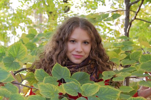 Image of beautiful young woman with autumn leaves