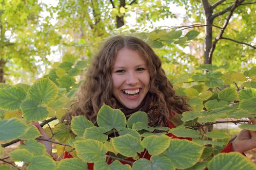 Image of beautiful young woman with autumn leaves
