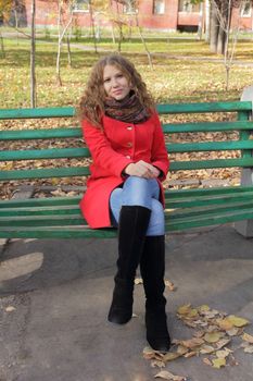 Portrait of thinking young woman in red coat