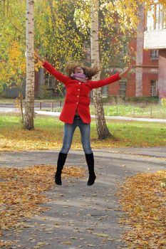 Image of beautiful young woman with autumn leaves