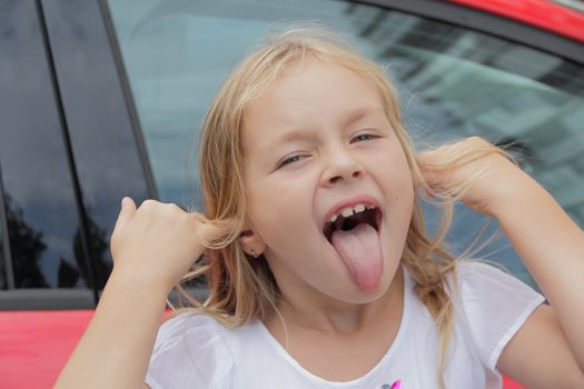 Portrait of girl with smile and makes faces