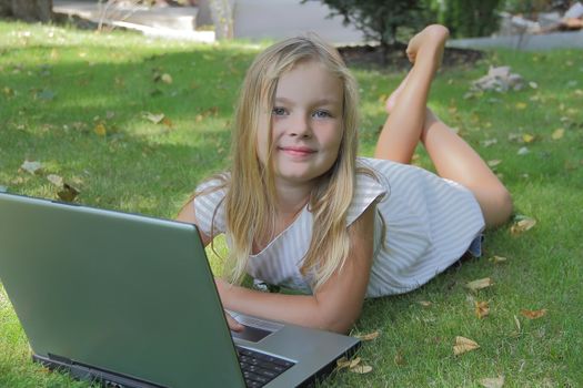 Image of girl with laptop in summer