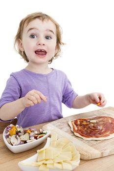 child making pizza in vertical image. studio shot isolated on white background