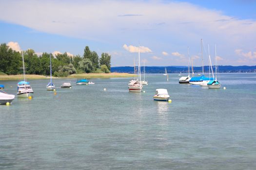 Lake of Constance with sailing boats and view of alps 