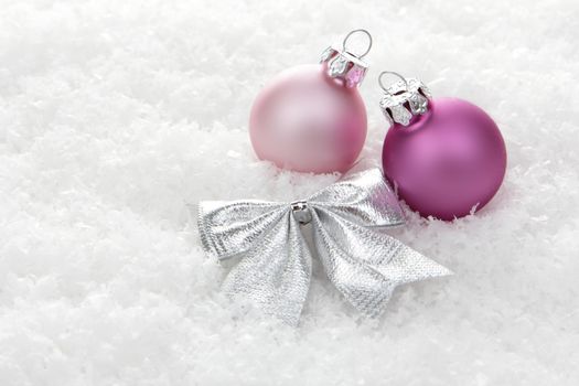 pink christmas balls with loop on snow 