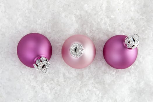 christmas, pink christmas balls on snow  