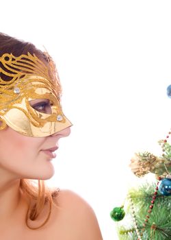 New masquerade mask on woman in the background of elegant Christmas tree isolated