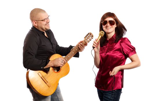 smiling couple plays guitar and sings on white background