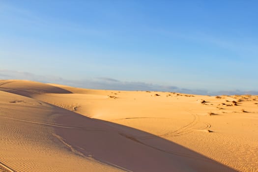 Sand desert landscape under bluy sky at sunny day