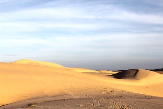 Sand desert landscape under bluy sky at sunny day