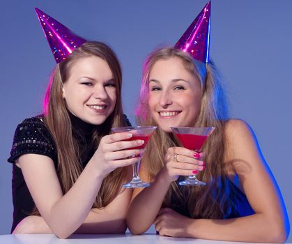 Close-up portrait of a smiling girl holding a cocktail