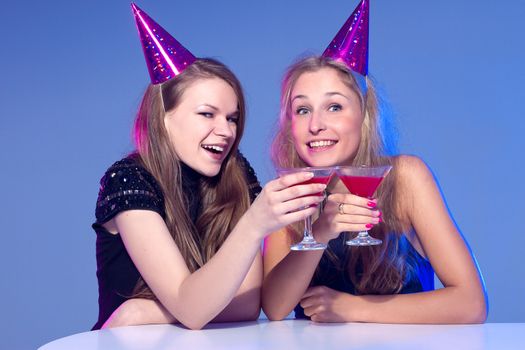 Close-up portrait of a smiling girl holding a cocktail