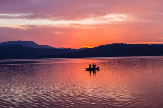 Dawn color reflections fishermen boat waters