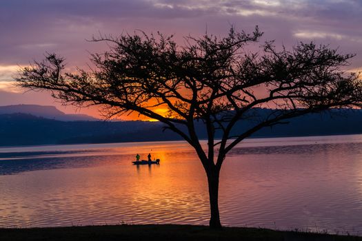 Dawn color reflections fishermen boat waters