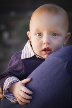 Adorable Infant Boy Portrait Outdoors with Dramatic Lighting.