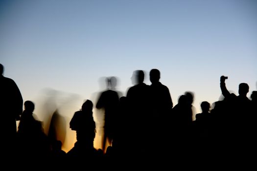 people silhouettes  on nemrut mountain waiting sunrise